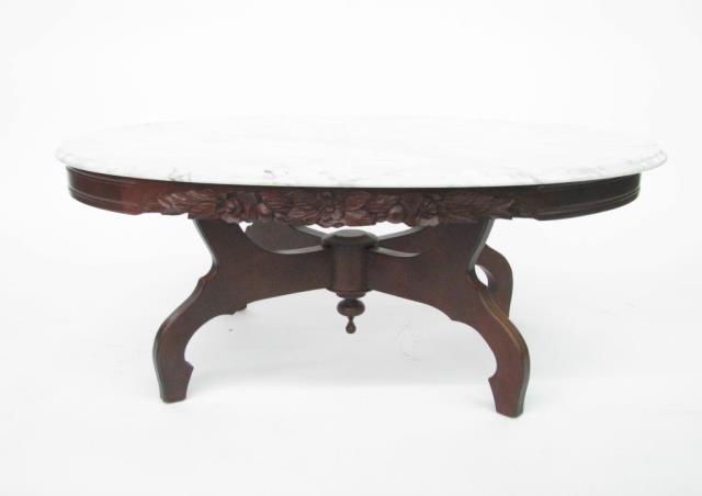 Appraisal: A mahogany oval marble top cocktail table with rose motif