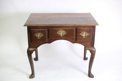 Appraisal: An oak lowboy table fitted a surround of three drawers