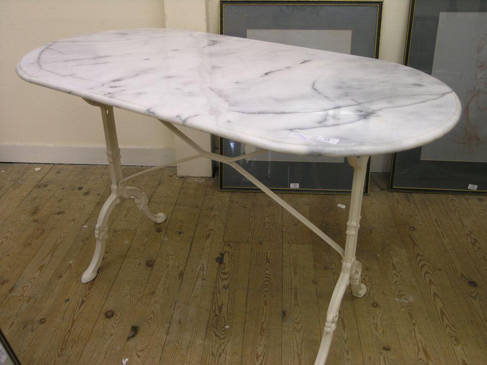 Appraisal: An oval metal framed table with marble top and one