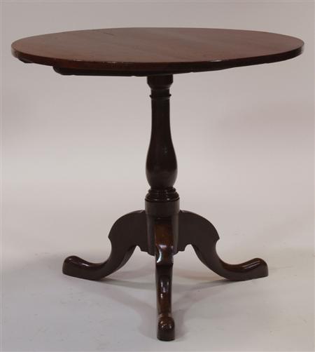 Appraisal: A Georgian oak tilt-top table the circular top raised on