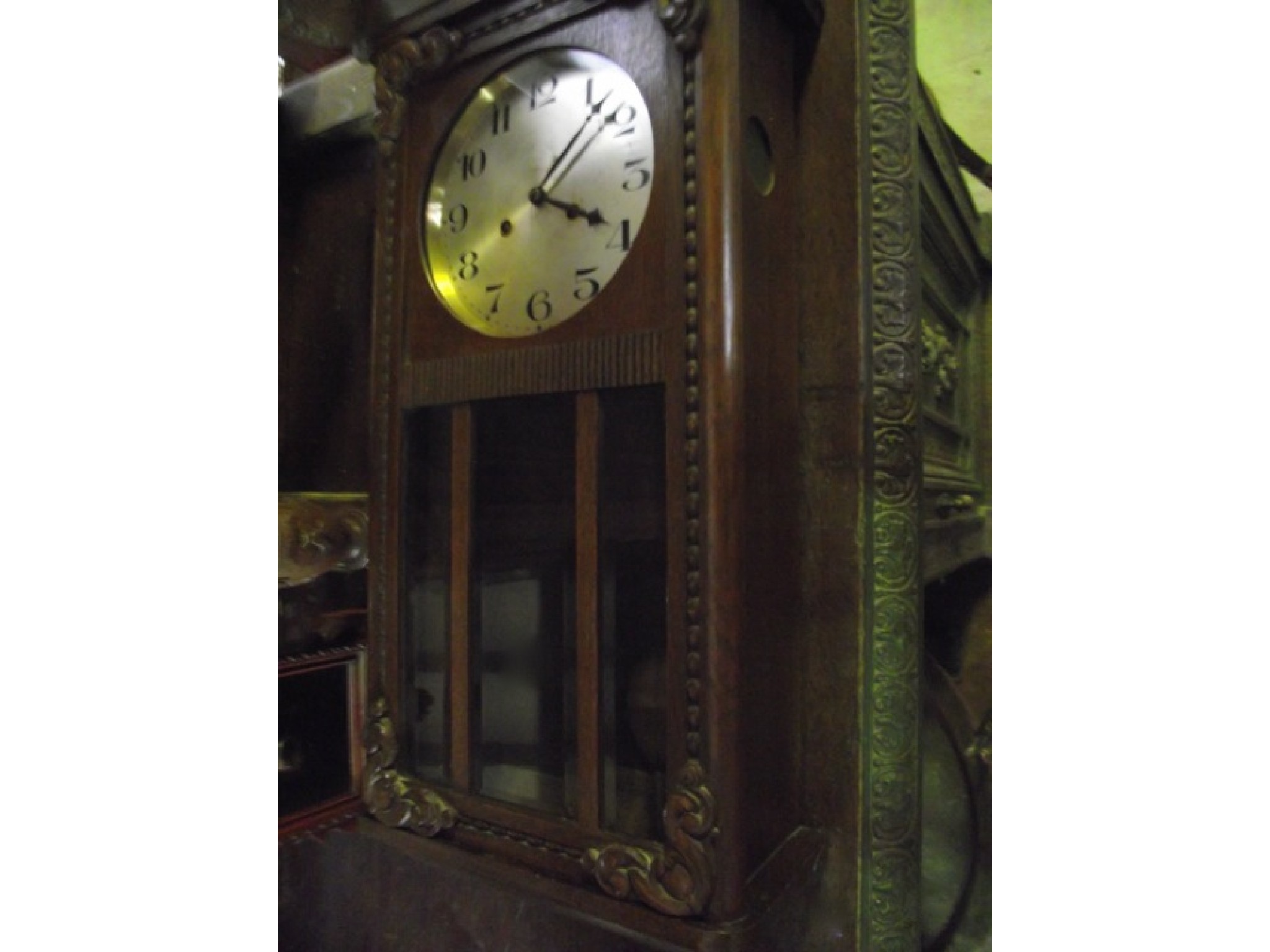 Appraisal: An oak cased wall clock with circular silvered dial and