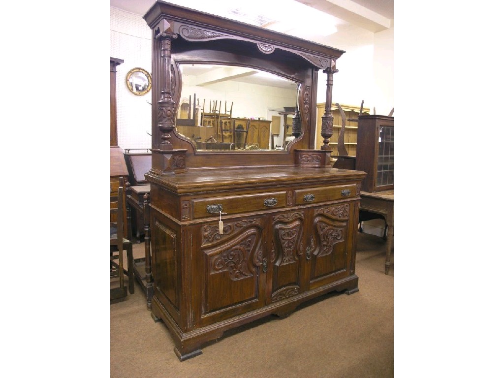 Appraisal: A late Victorian Art Nouveau walnut sideboard tall raised back