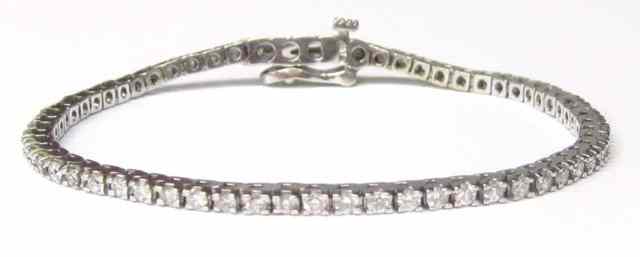 Appraisal: DIAMOND AND WHITE GOLD BRACELET k gold set with round-cut