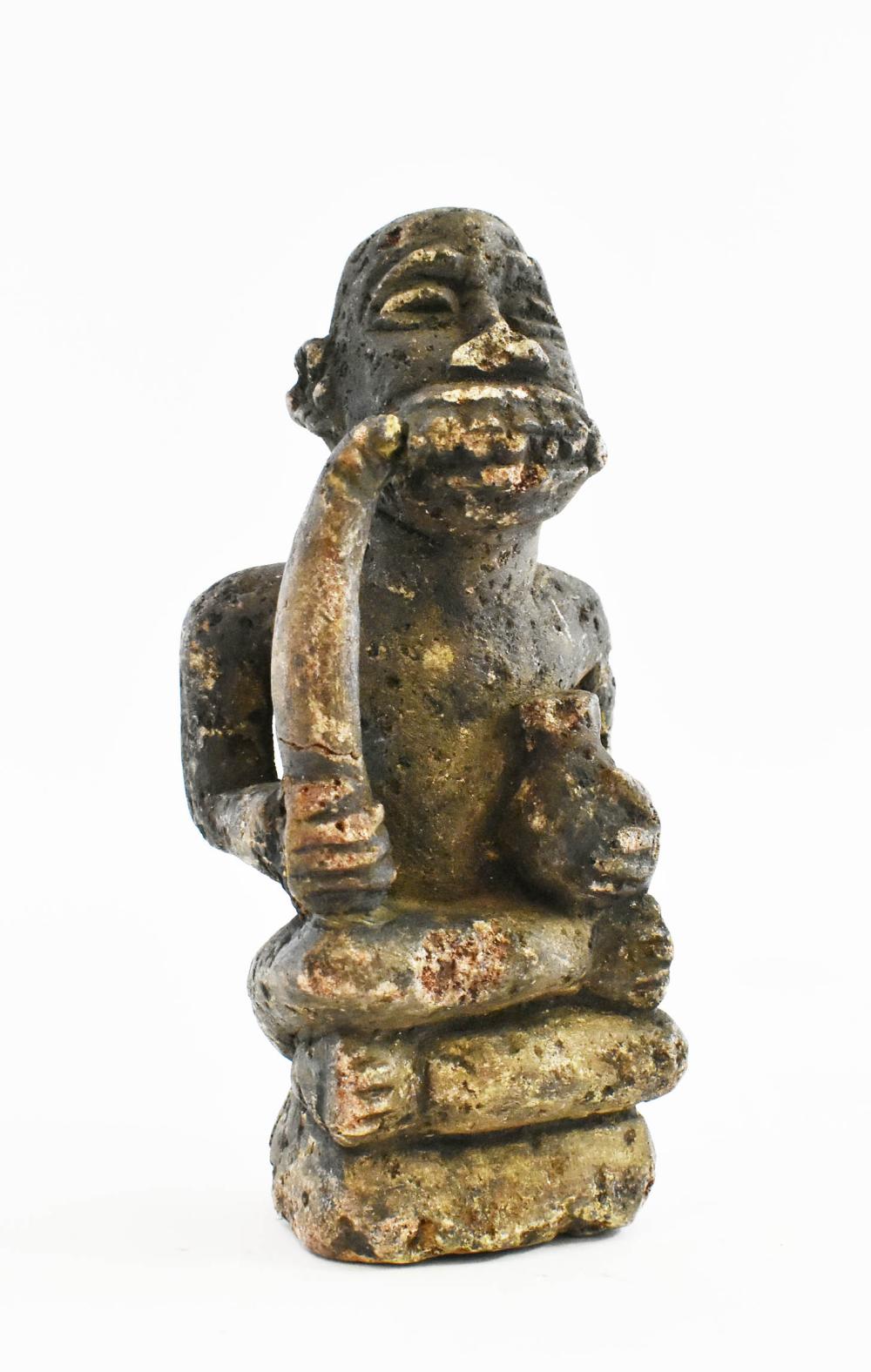 Appraisal: AFRICAN LAVA STONE CARVED FIGURE OF A MANThe figure with