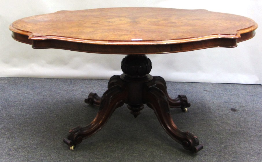 Appraisal: A Victorian figured walnut centre table the shaped top on