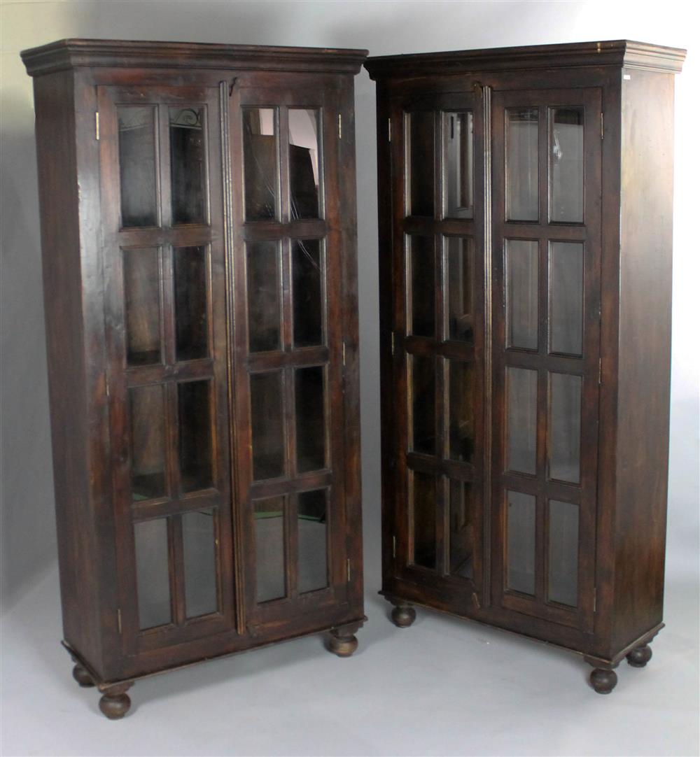 Appraisal: PAIR OF DARK STAINED HARDWOOD AND GLASS CABINETS made in