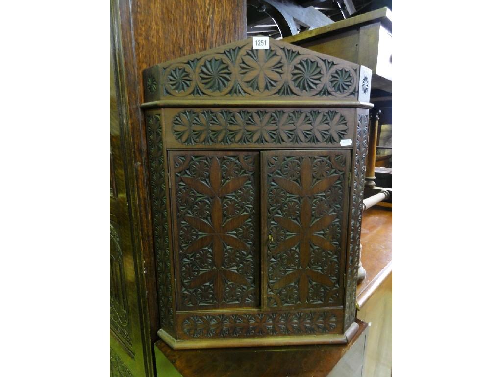 Appraisal: A small Edwardian hanging corner cupboard with profuse chip carved