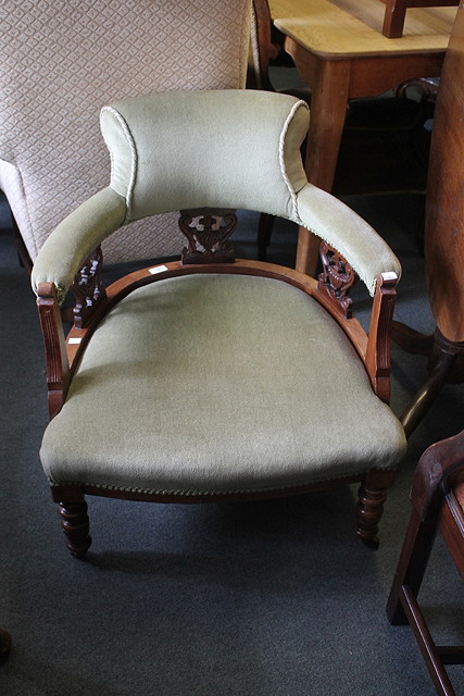 Appraisal: AN EDWARDIAN WALNUT TUB CHAIR with upholstered scroll back urn