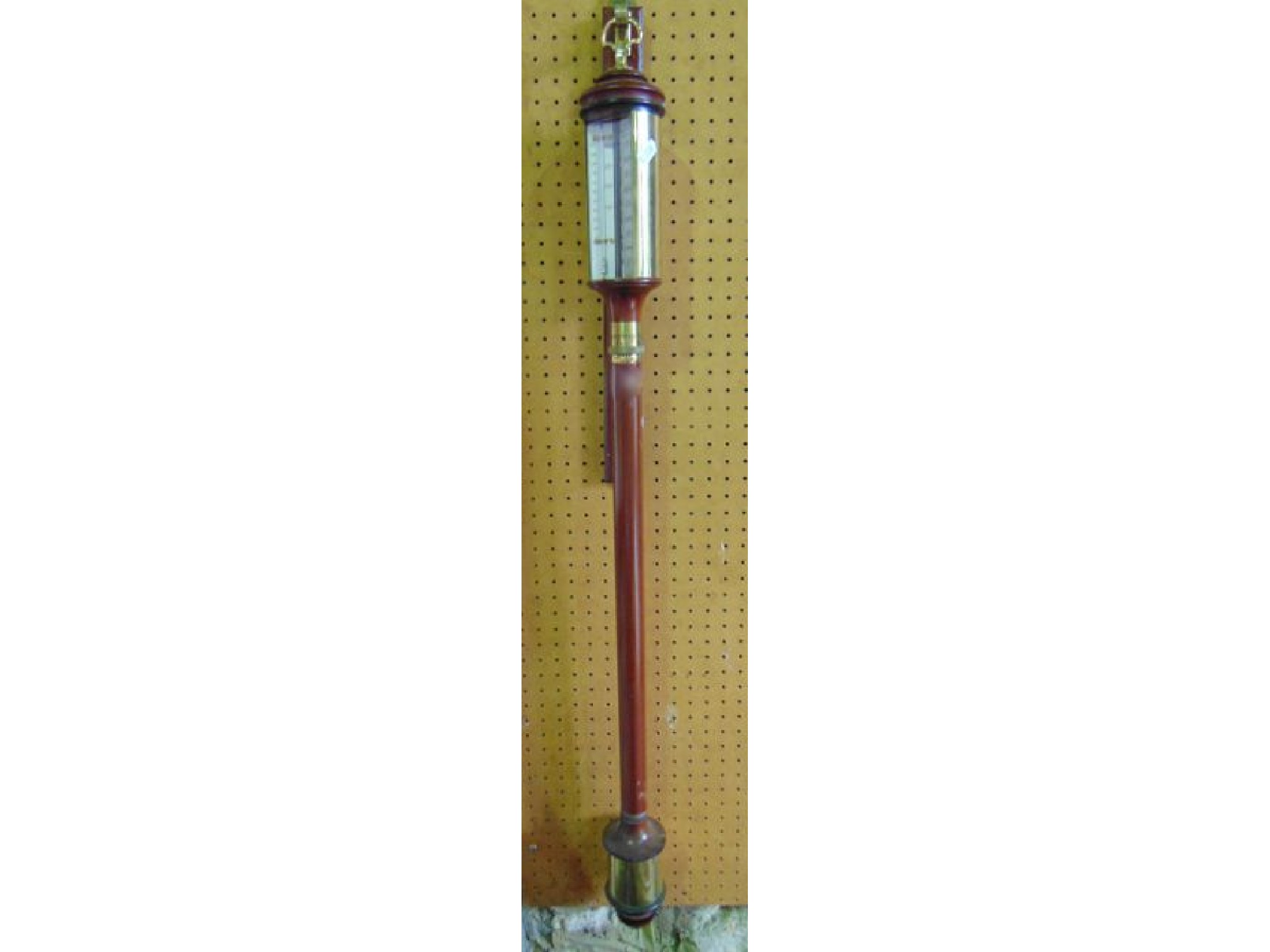 Appraisal: A reproduction marine stick barometer with brass fittings with silvered