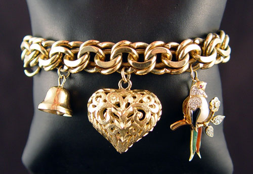 Appraisal: TIFFANY CO GOLD CHARM BRACELET Link charm bracelet Stamped ''Made