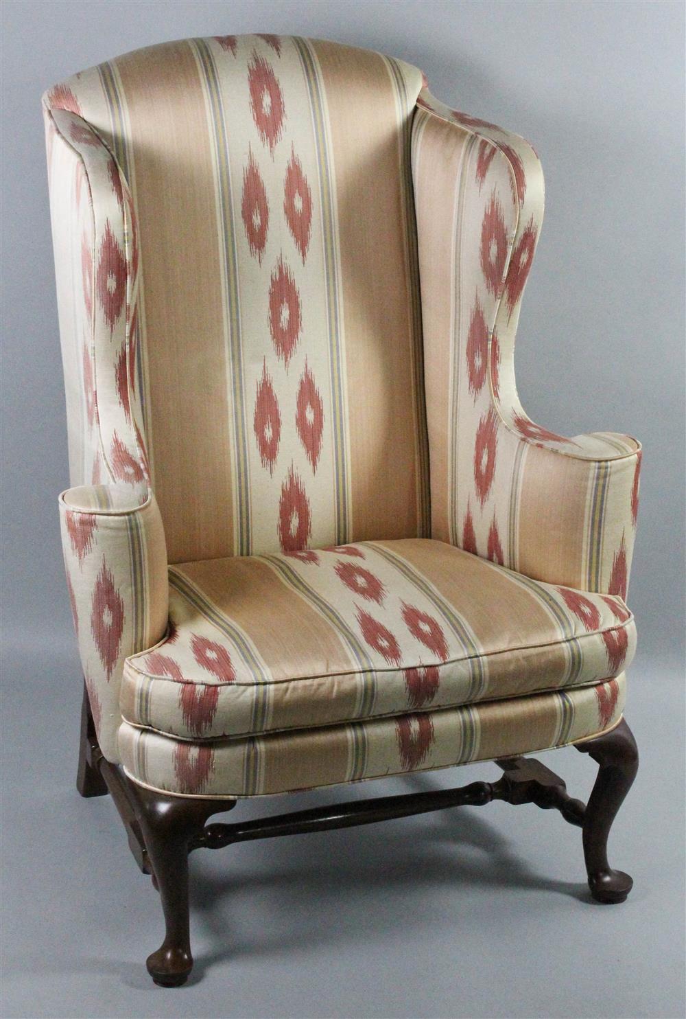 Appraisal: QUEEN ANNE STYLE UPHOLSTERED WING CHAIR having an arched crest