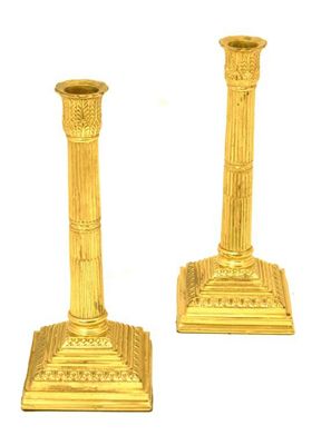 Appraisal: A pair of brass candlesticks with stop fluted columns and