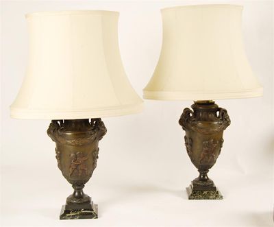 Appraisal: A pair of French bronzed table lamps raised on green