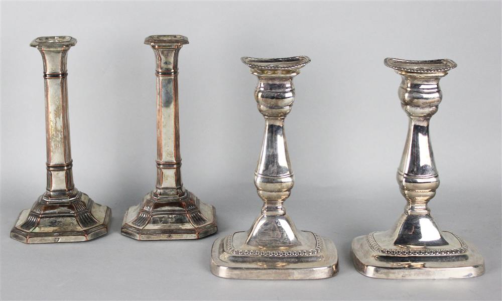 Appraisal: TWO PAIRS OF SILVERPLATED CANDLESTICKS one pair columnar with reeded