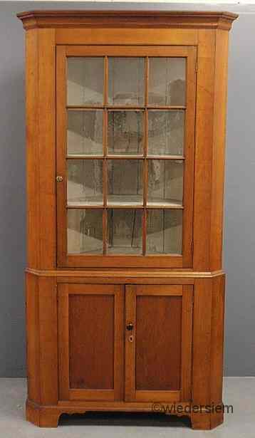 Appraisal: Cherry two-piece corner cupboard c with a molded cornice above