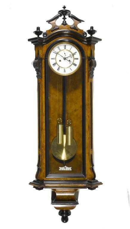 Appraisal: AN AUSTRIAN WALNUT 'VIENNA' WALL CLOCK with ebonised mouldings the