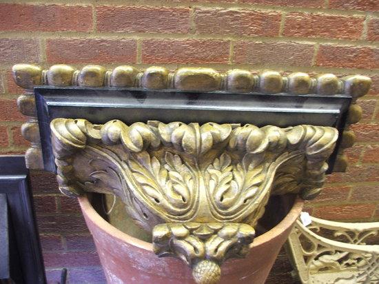 Appraisal: A PAIR OF CONTINENTAL EBONISED AND GILTWOOD WALL BRACKETS with