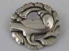 Appraisal: Georg Jensen a silver brooch with a dove within a