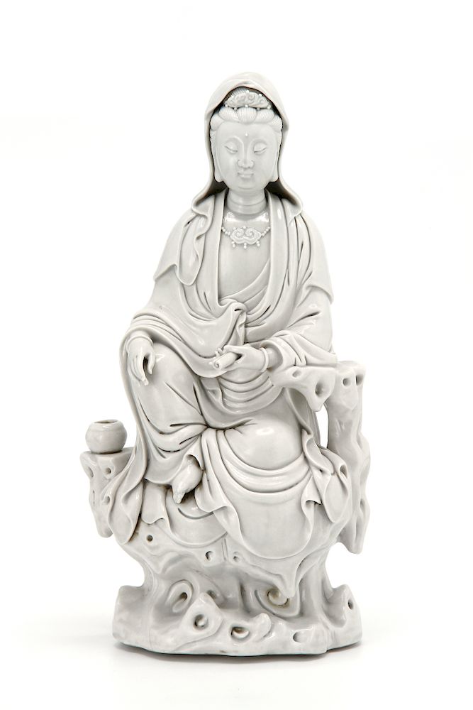 Appraisal: Dehua Figure of Guanyin Portrayed seated on rockwork supporting a