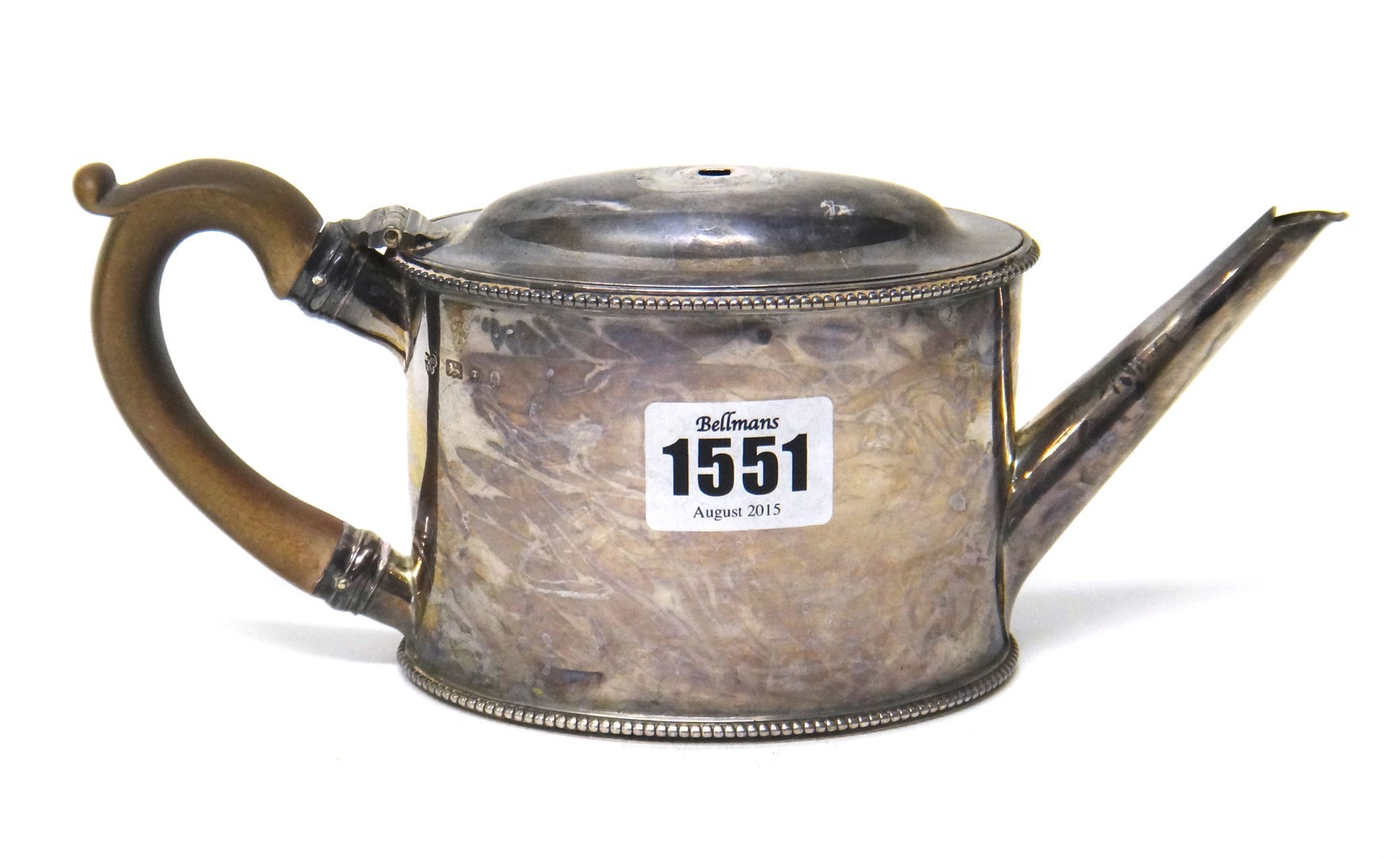 Appraisal: A silver teapot of plain oval form with beaded rims