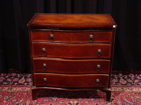 Appraisal: CHIPPENDALE STYLE MAHOGANY CHEST th c the tooled leather serpentine