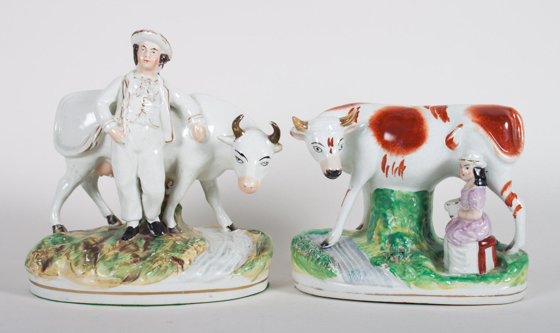 Appraisal: Two Staffordshire cow figural groups second half- th century farmer