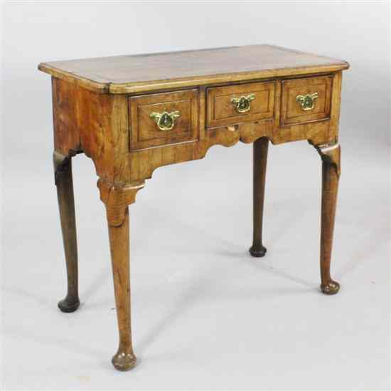 Appraisal: An early th century walnut lowboy with re-entrant top and