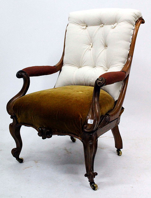 Appraisal: A VICTORIAN ROSEWOOD OPEN ARMCHAIR with carved scrolling decoration to