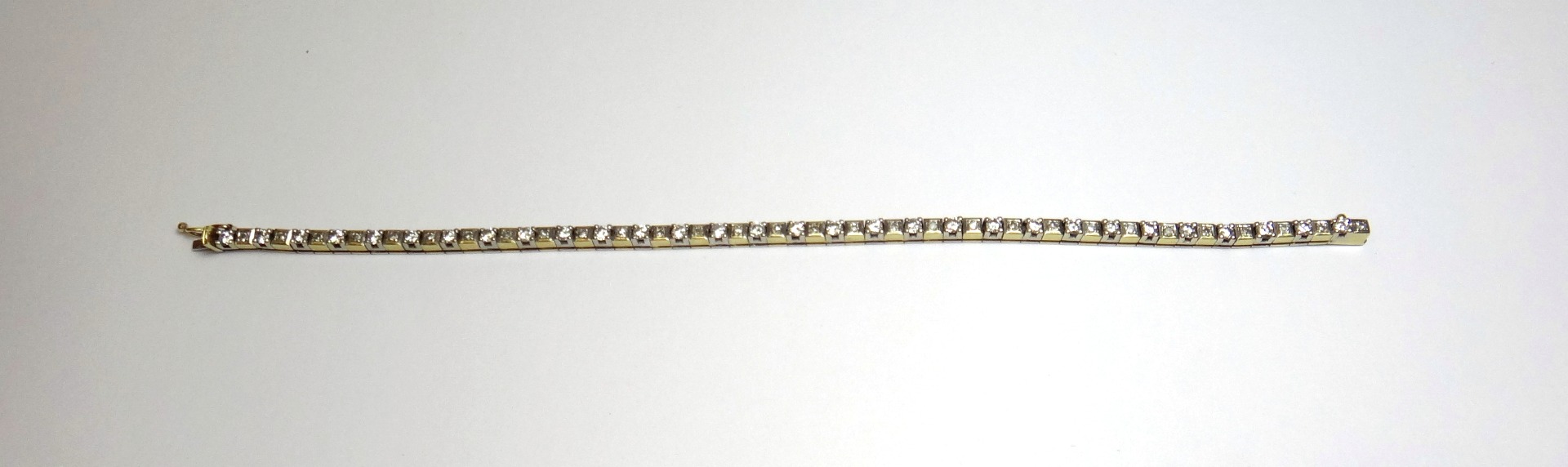 Appraisal: An ct two colour gold and diamond set line bracelet