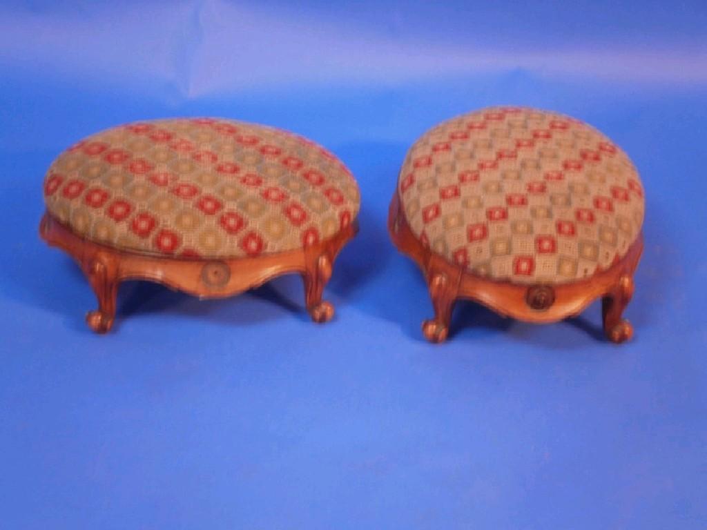 Appraisal: A pair of footstools with oval wool work overstuffed pads