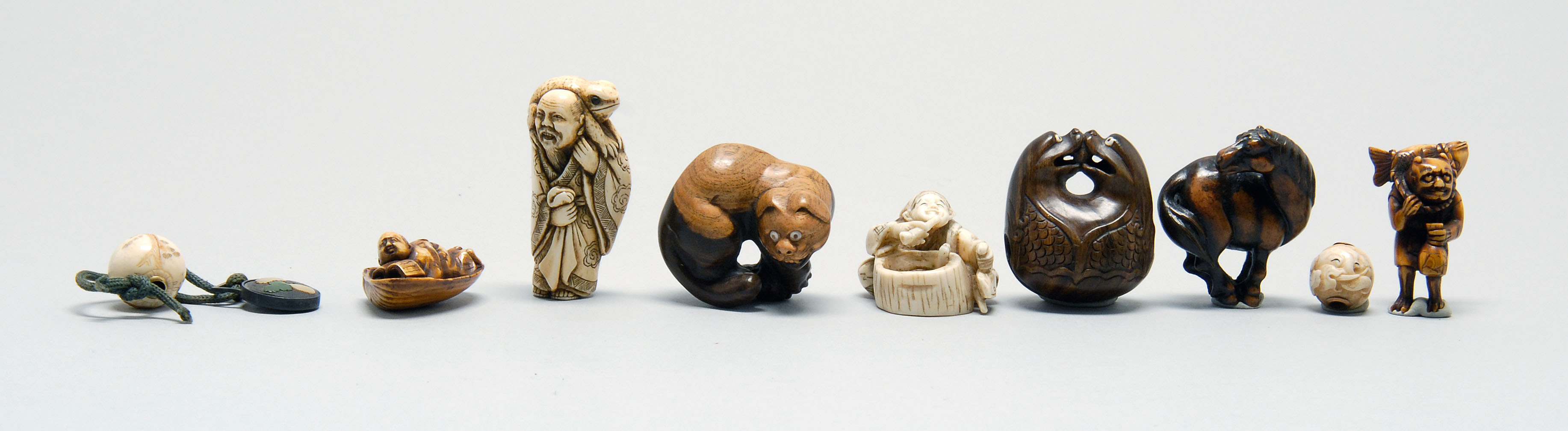 Appraisal: SEVEN NETSUKE AND TWO OJIME A wood bell Metropolitan Museum