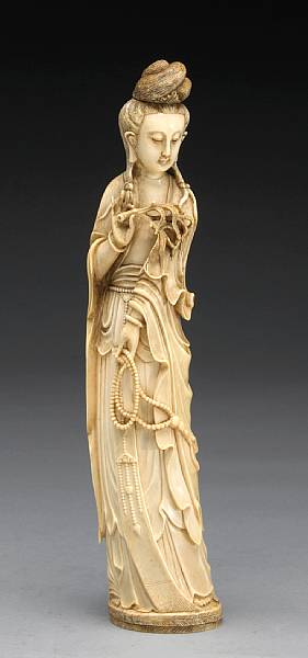 Appraisal: A carved and tinted ivory figure of Guanyin Shown standing