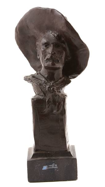 Appraisal: A patinated bronze bust of a cowboy after Remington height