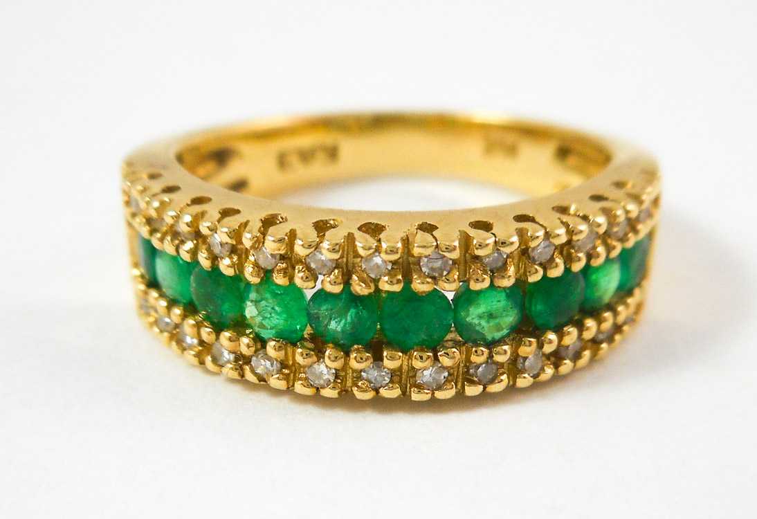 Appraisal: EMERALD DIAMOND AND FOURTEEN KARAT GOLD RING with a row