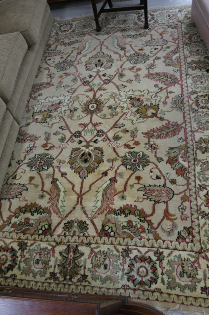 Appraisal: HAND KNOTTED ORIENTAL CARPET Indo-Persian overall floral design on khaki