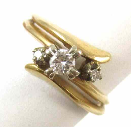 Appraisal: DIAMOND AND FOURTEEN KARAT GOLD RING set with three round-cut