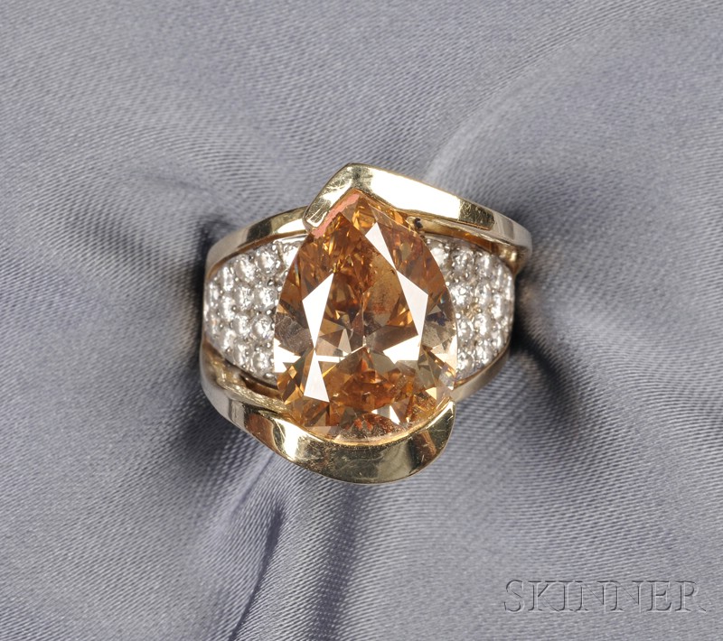 Appraisal: Colored Diamond and Diamond Ring the pear-shape faceted diamond measuring