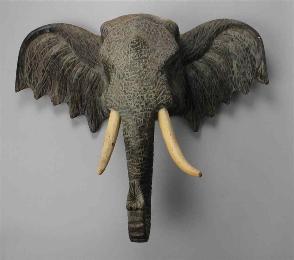 Appraisal: THAI CARVED ACACIA ELEPHANT HEAD with painted tusks and erect