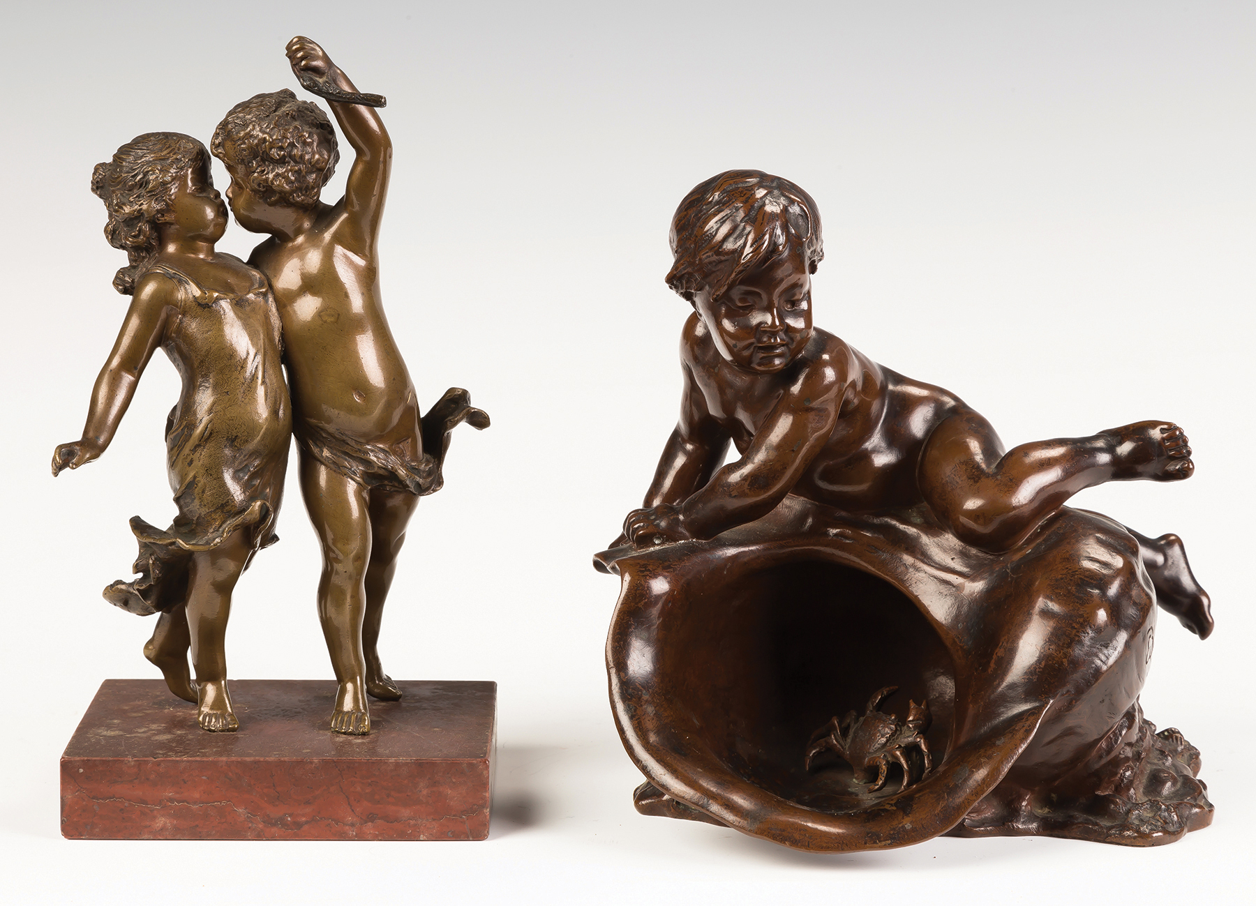 Appraisal: Two Bronze Putti Sculptures C Bronze of dancing putti Louis-Ernest