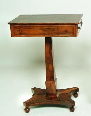 Appraisal: A REGENCY ROSEWOOD LAMP TABLE of rounded oblong form frieze