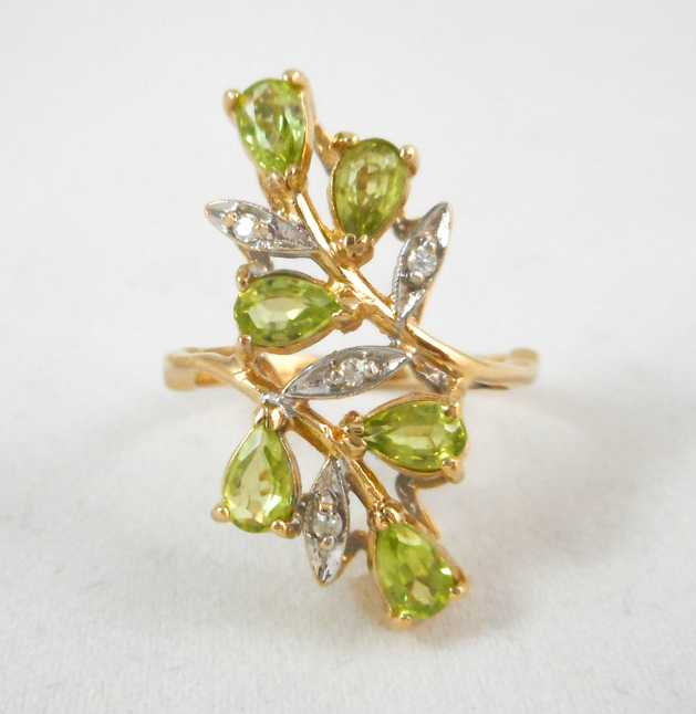 Appraisal: PERIDOT DIAMOND AND FOURTEEN KARAT GOLD RING set with six