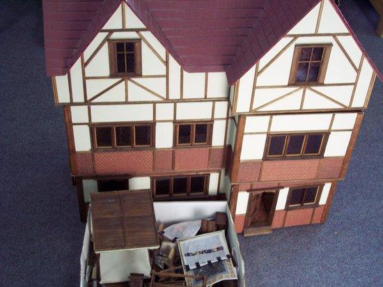 Appraisal: A Tudor style doll's house together with a large quantity