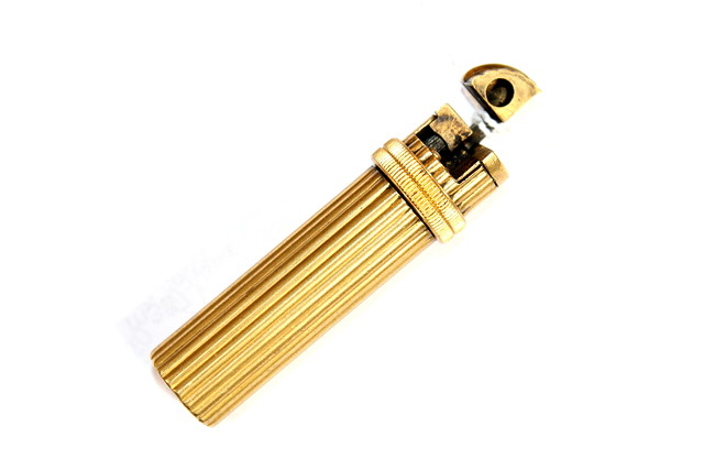 Appraisal: A HERMES OF PARIS GILT METAL CYLINDRICAL CIGARETTE LIGHTER stamped