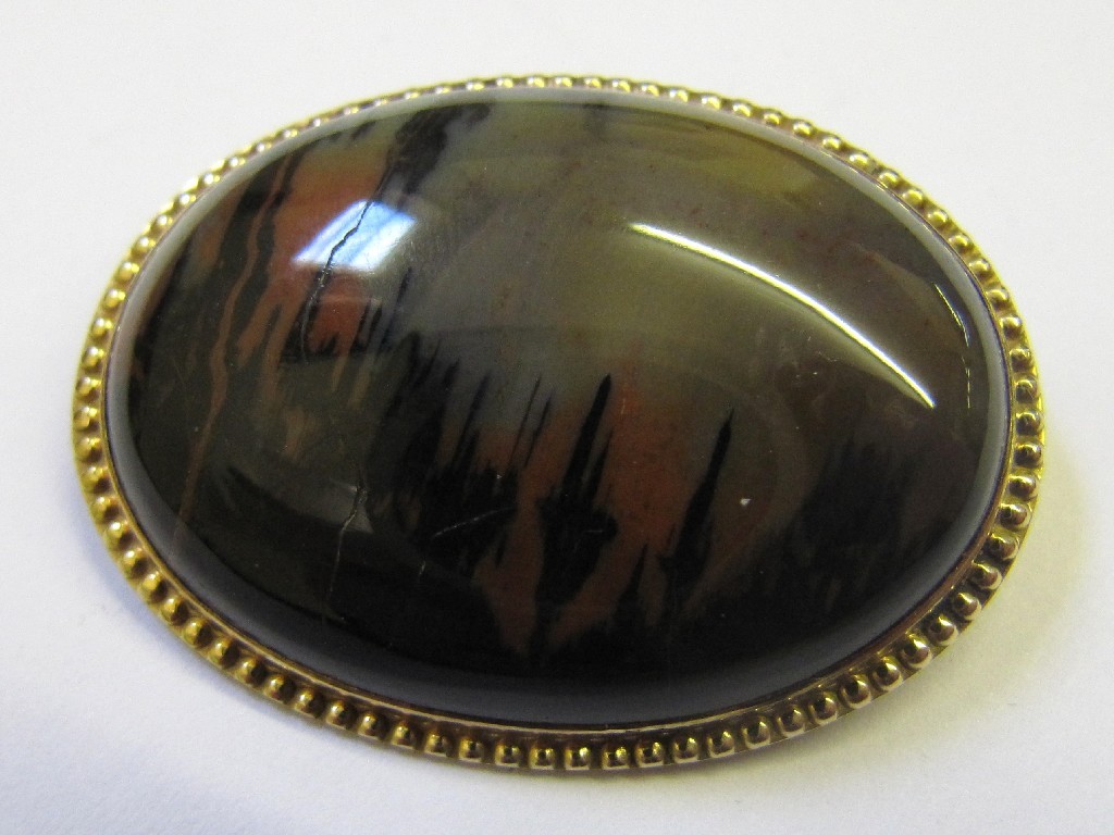 Appraisal: Polished pebble oval brooch in ct gold mount