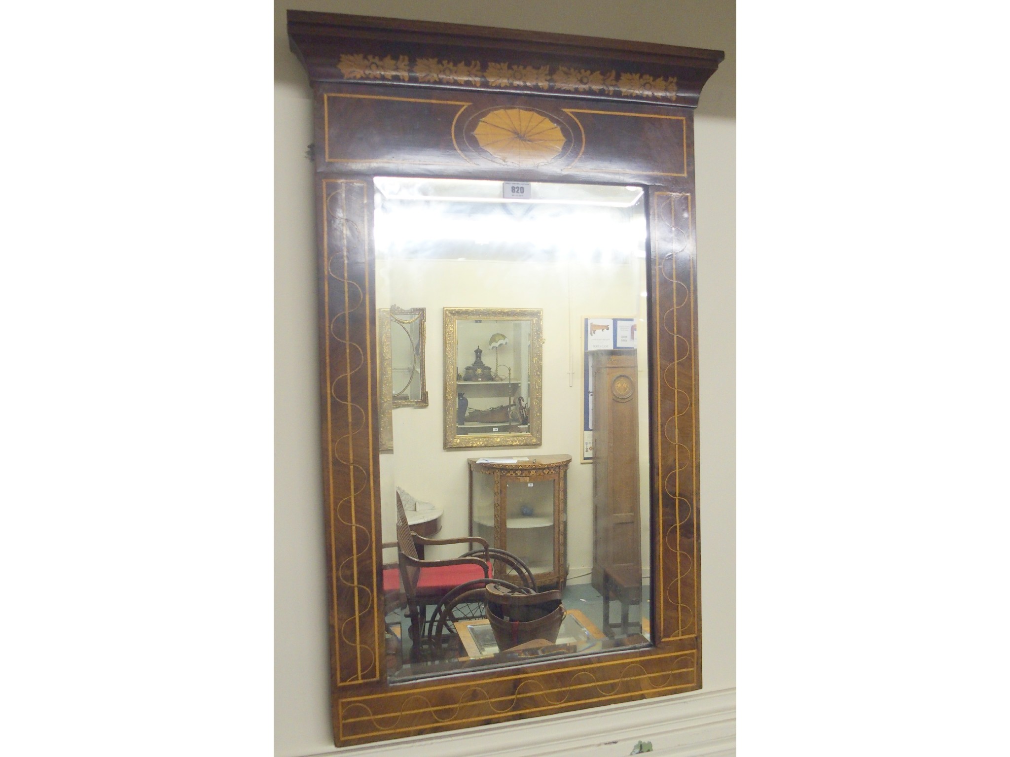 Appraisal: A mahogany inlaid mirror with bevelled glass