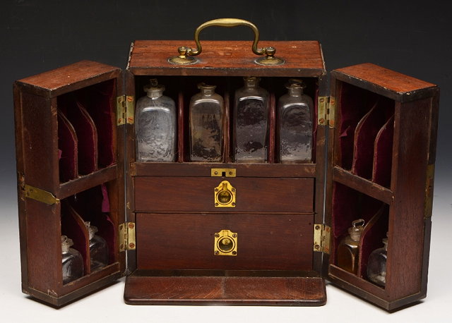 Appraisal: A GEORGE III APOTHECARY'S MAHOGANY CABINET with overhead brass swan