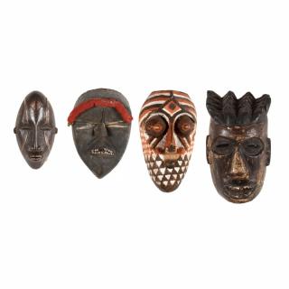 Appraisal: Four West African Masks the first an Ibo mask with