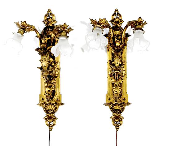 Appraisal: Pair Continental two-light gilt-metal sconces circa foliate and shell-decorated backplate