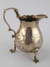 Appraisal: A Georgian embossed silver cream jug on three paw feet