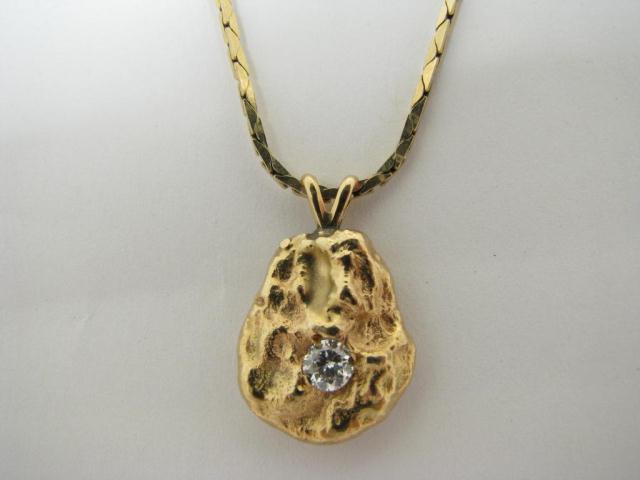 Appraisal: Lady's gold nugget pendant with approximately ct diamond on a